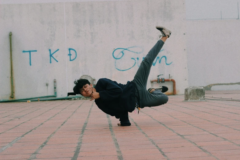 a young man does the splits on his skateboard
