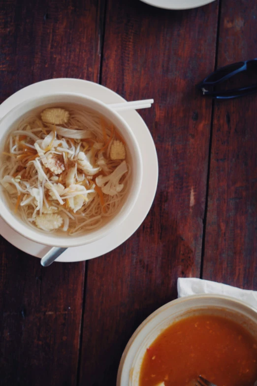 soup with meat and noodles served on wooden table