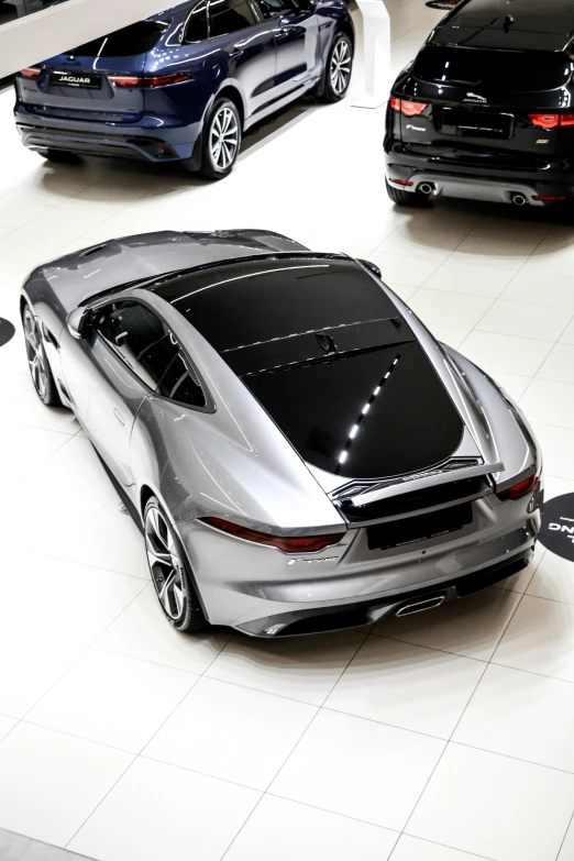 four different models of cars on display at an automotive show