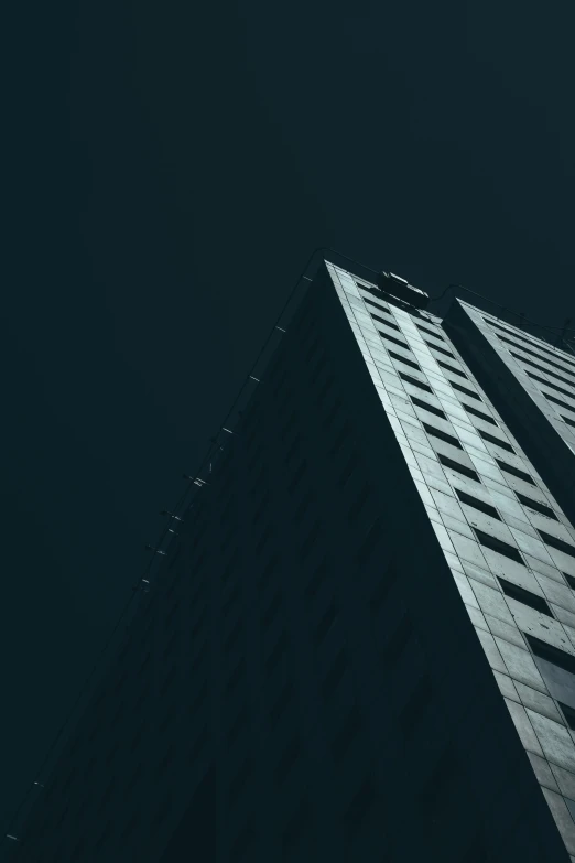 black and white pograph of building looking up at night sky