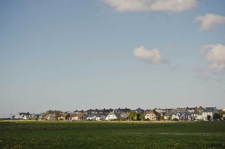 the village stands out against a beautiful green landscape