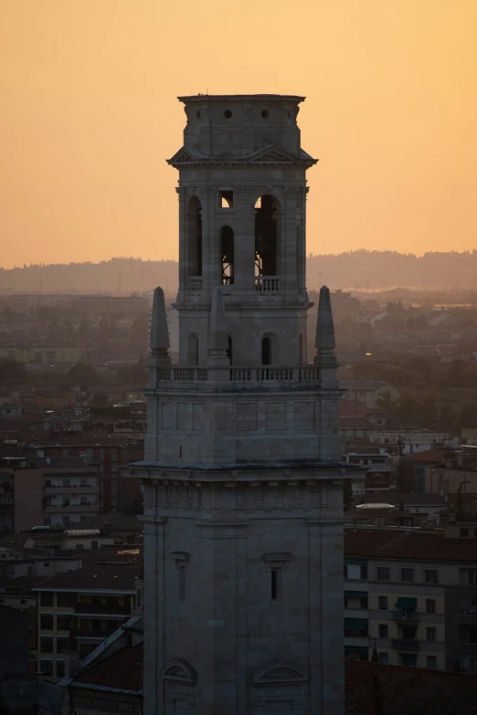 a clock tower stands in front of a cityscape