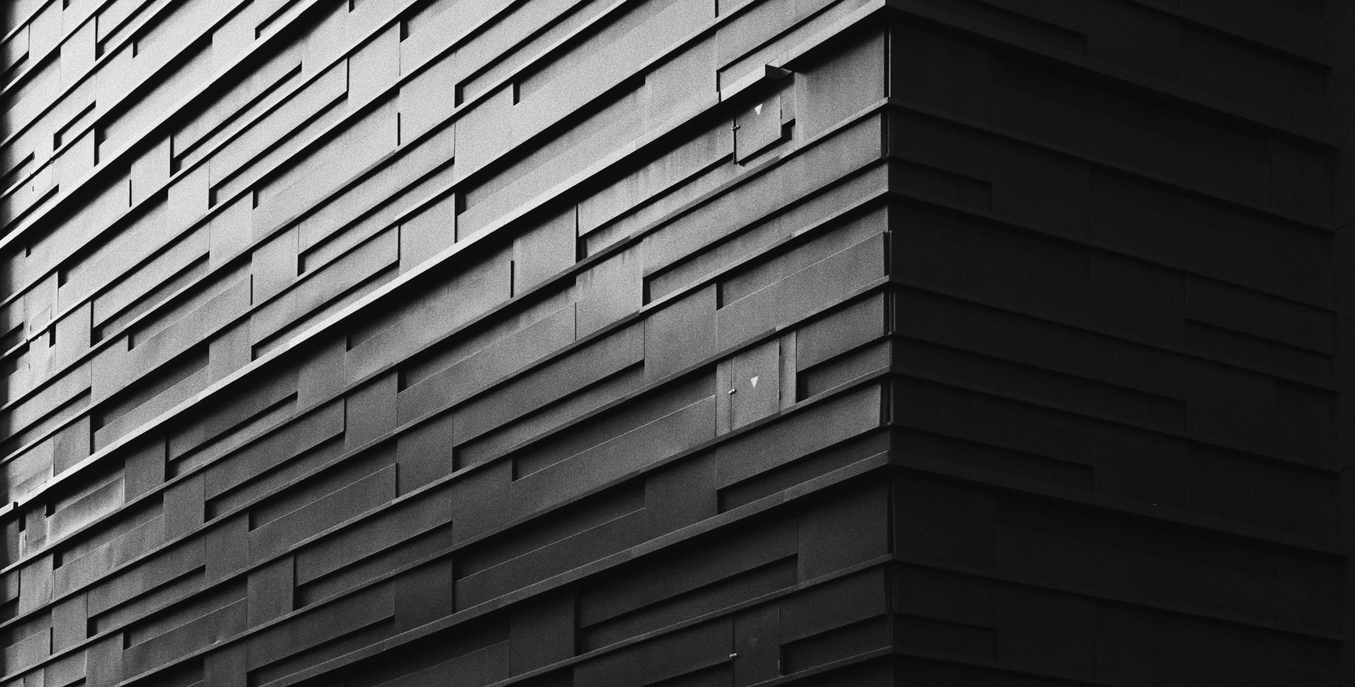 a black and white po shows the corner of a tall building