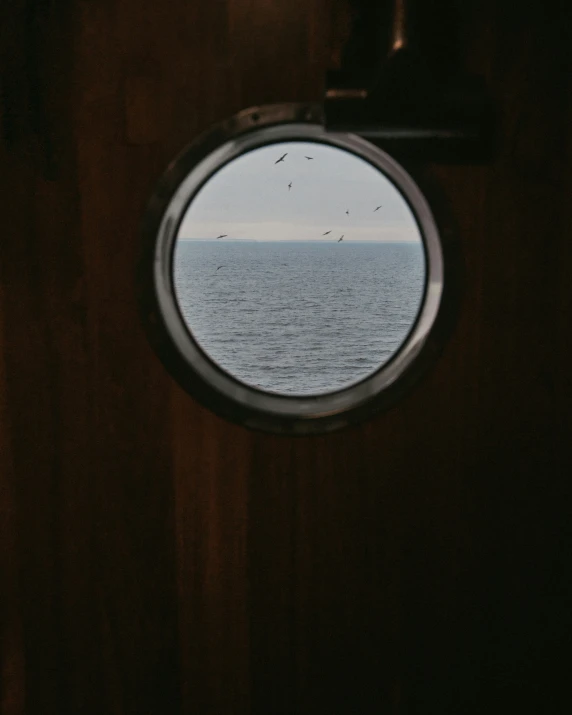 round window with sea in the background