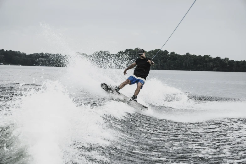 a person on a ski with water splashing behind him