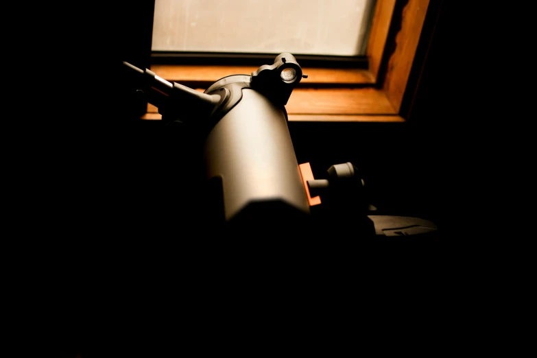 an empty metal container is shown next to a window