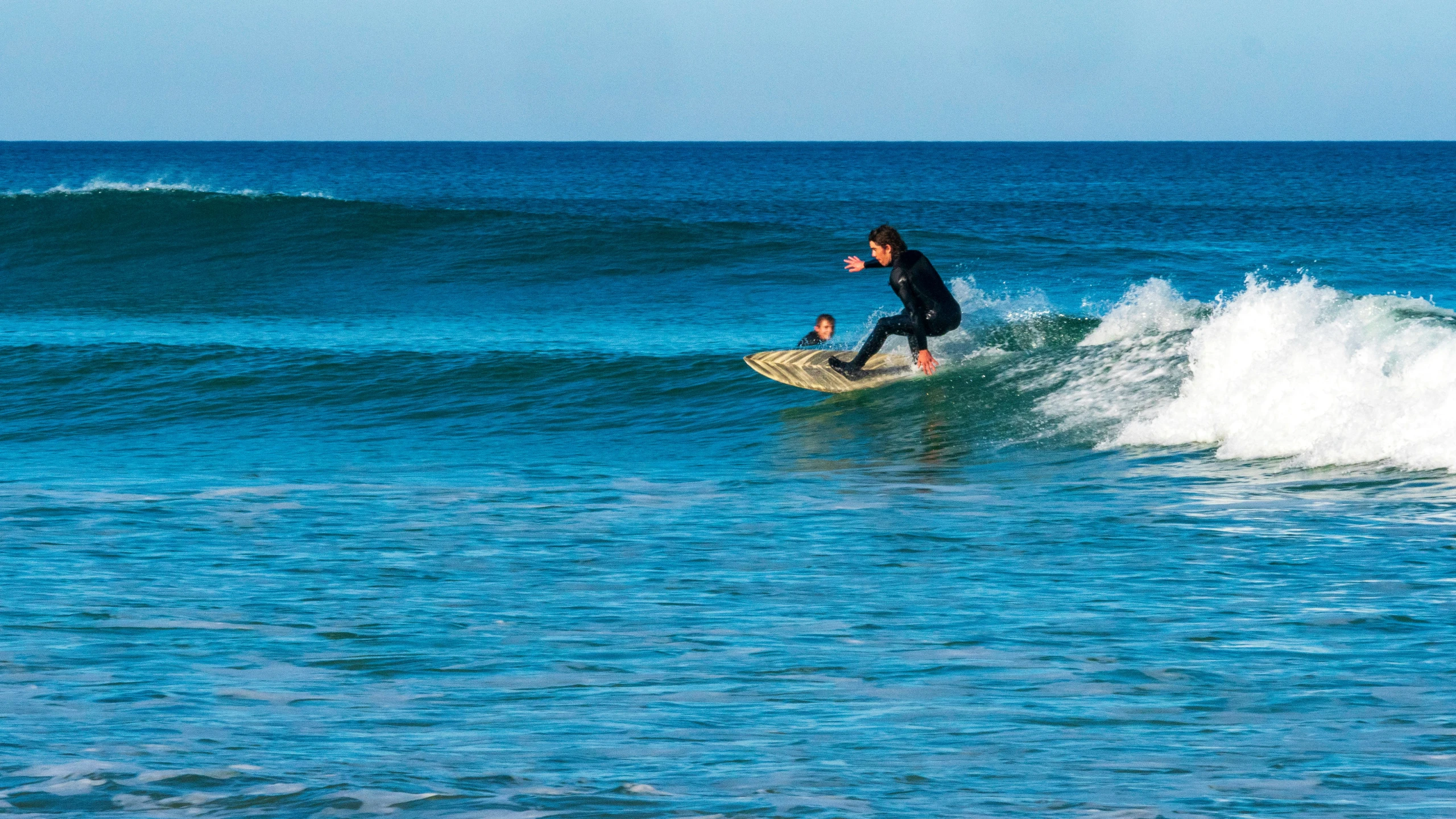 a man riding a wave on top of a surfboard