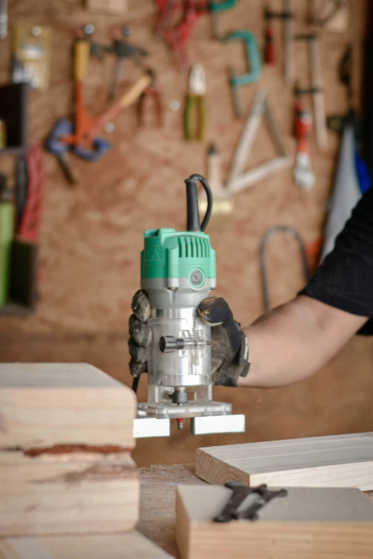 a man using a machine to make wood