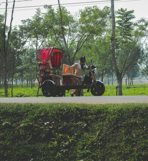 a horse drawn cart is driving along a paved road