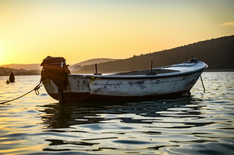 a boat floating in the middle of a body of water