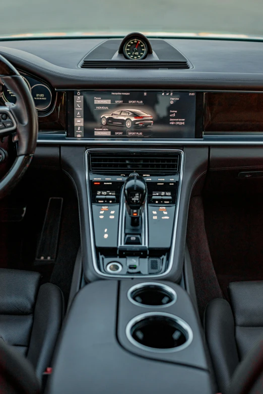 dashboard of car with black leather seating and dark carpeting