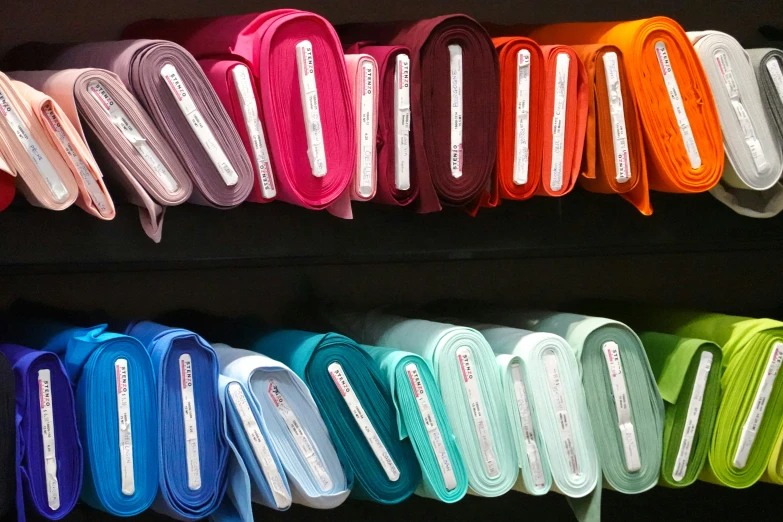 colorful ribbons stacked up on racks in a store