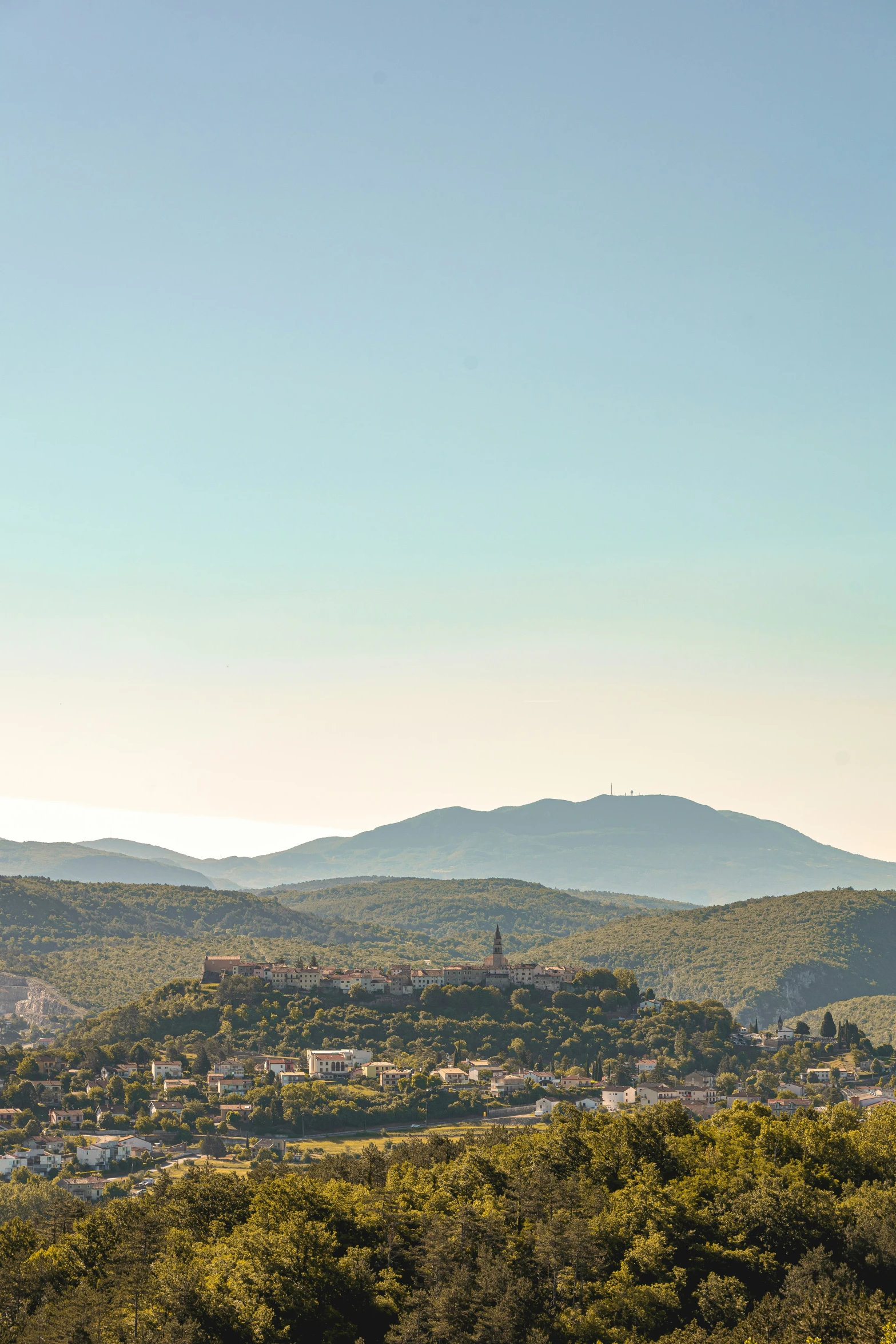 there are hills in the background, and a clock tower to the left