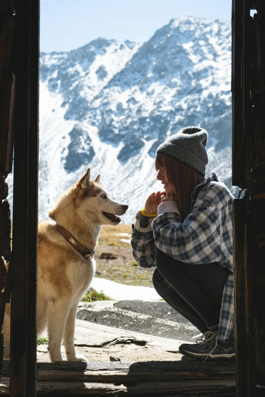 there is a woman and a dog drinking tea together