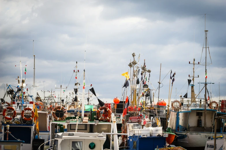 multiple boats are lined up on the water