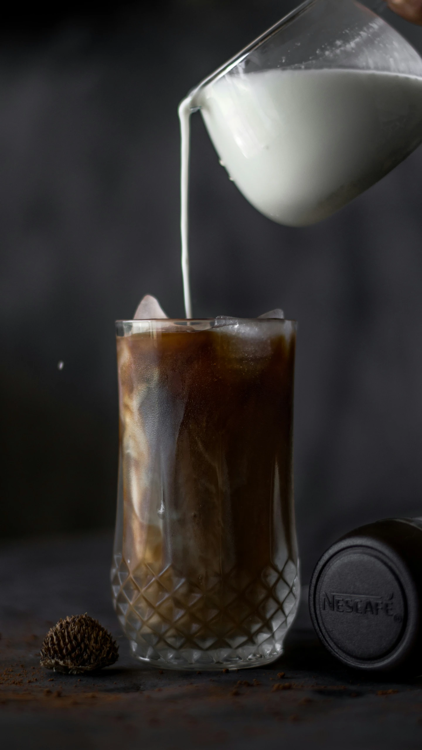 a glass is being poured with white substance