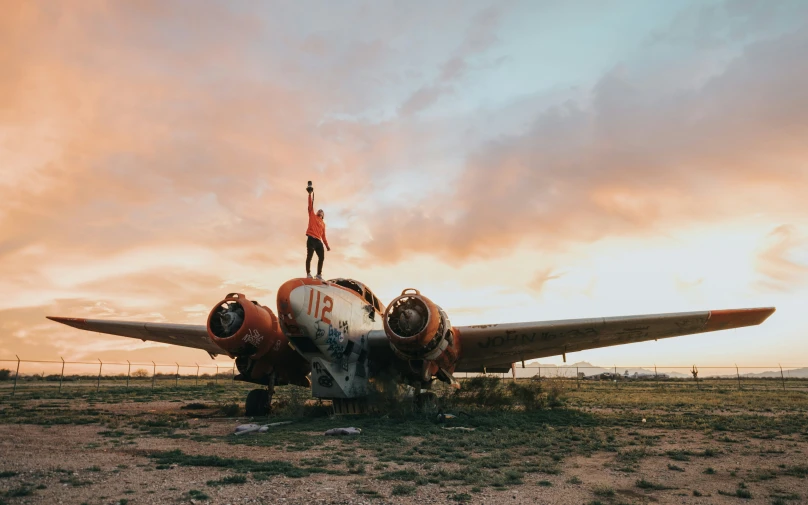 a person standing on top of an airplane