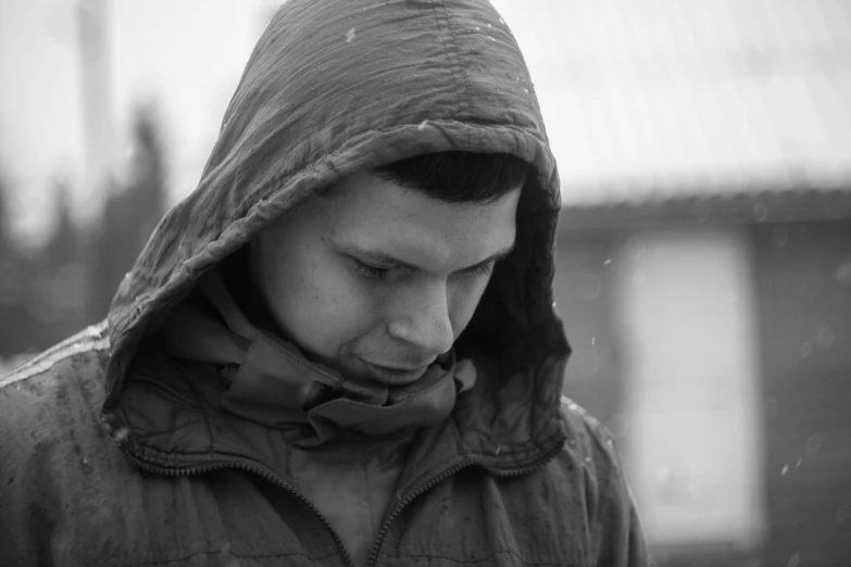 black and white image of man with hooded jacket