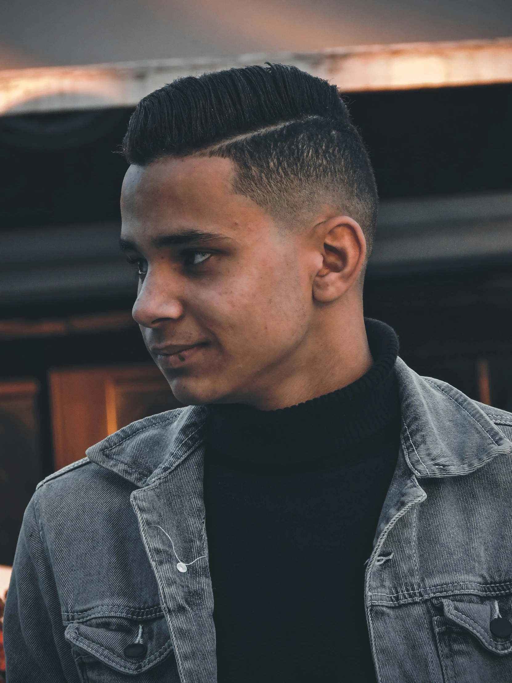 a man with a high ponytail undercut wearing a jacket