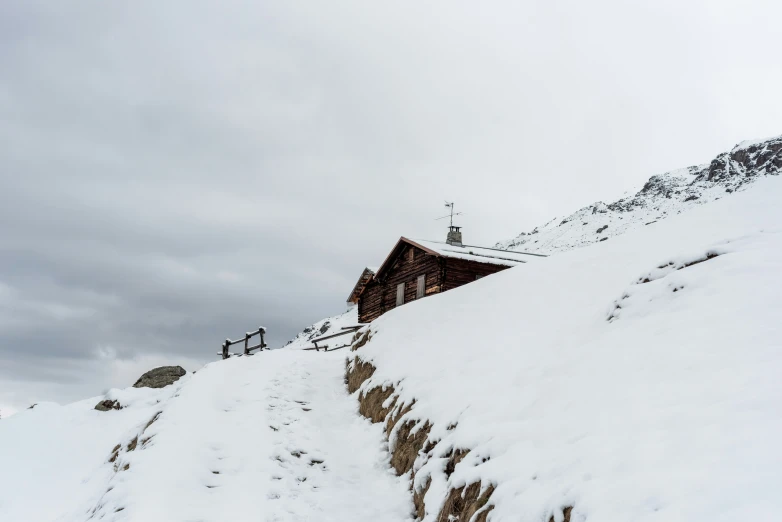 a group of people walking up the side of a snowy mountain