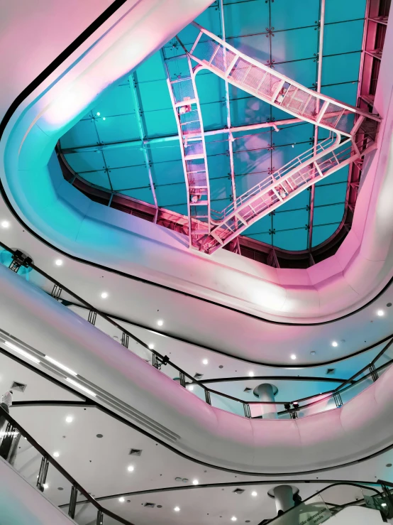 a view of a futuristic staircase and blue sky through the ceiling