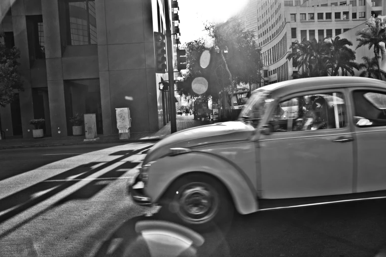 a car traveling through the city at a speed limit