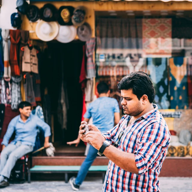 the young man is checking his cell phone