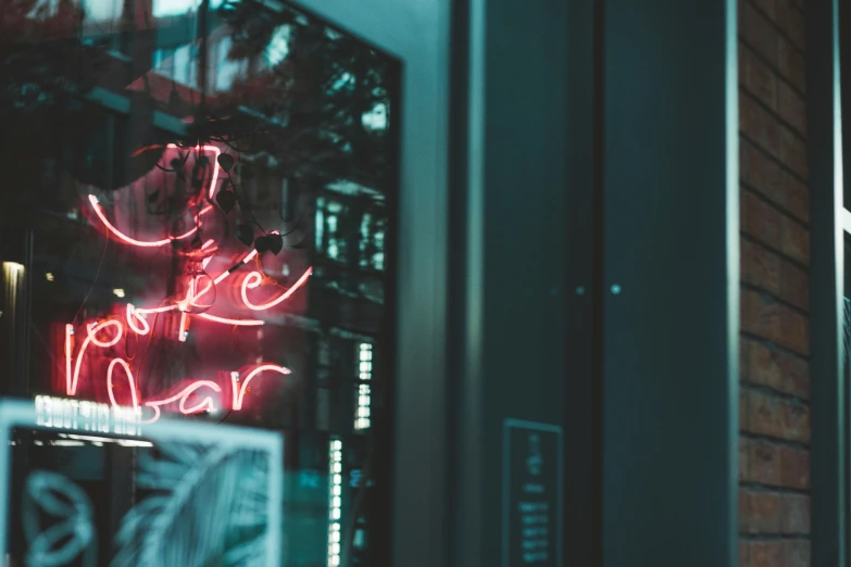 the side of a building with neon signs in front of it