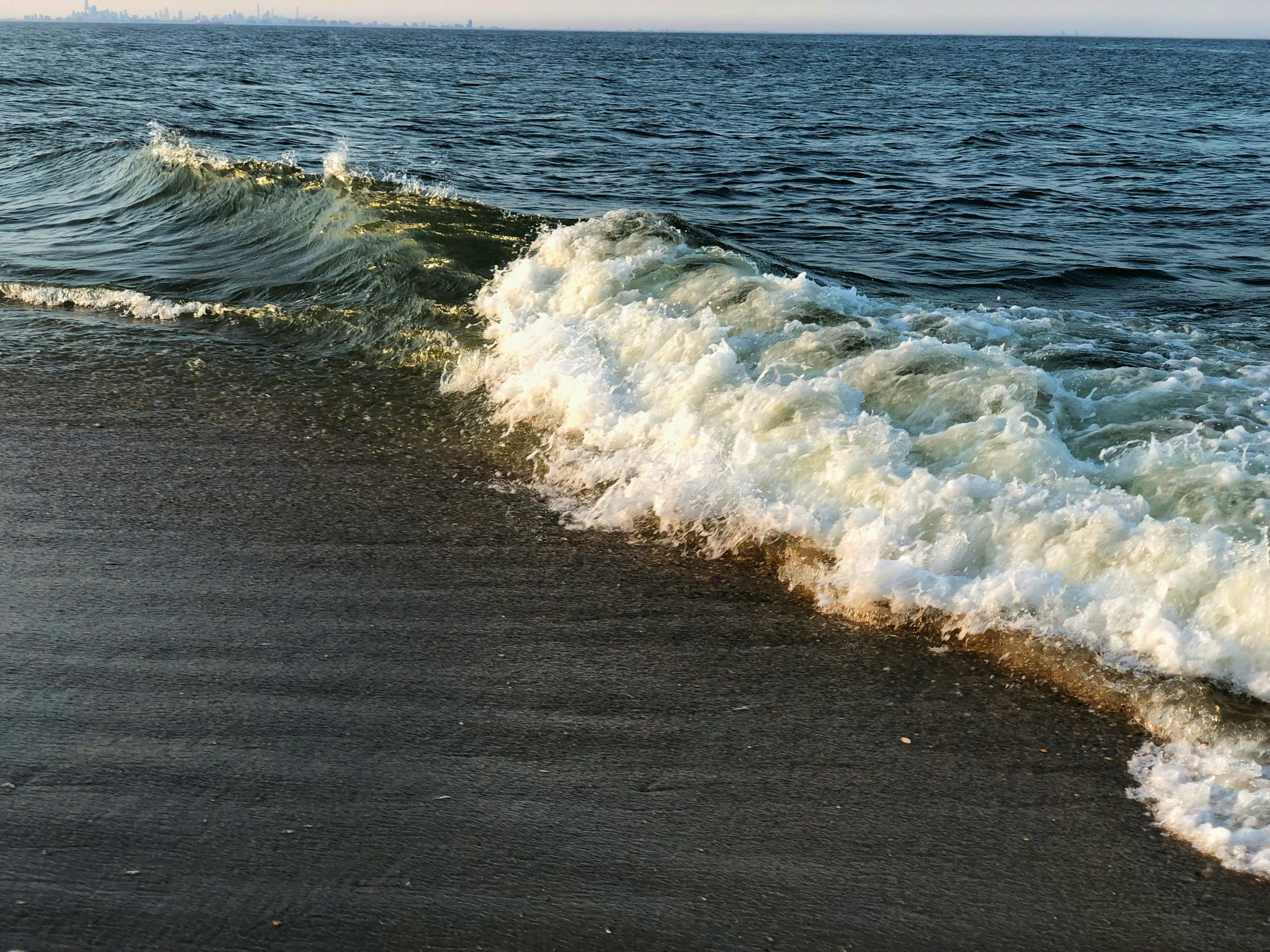 a wave on the shore of an ocean