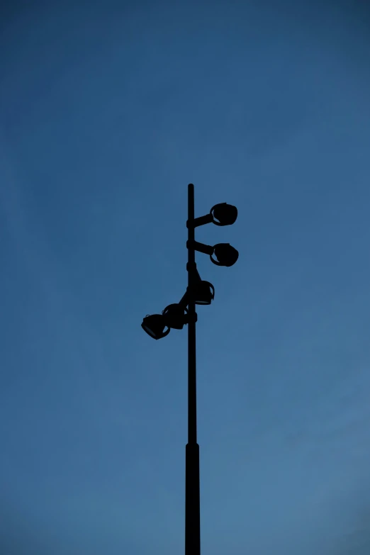 a traffic light with two street lights on the pole