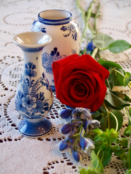 a close up view of a vase and roses