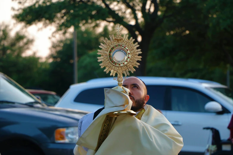 a priest in the street wearing a large golden cross