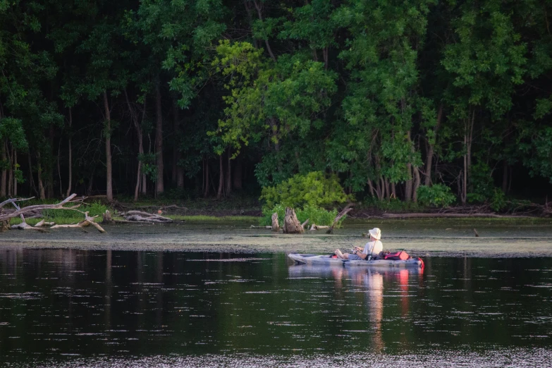 a person in a boat with a paddle is in the water