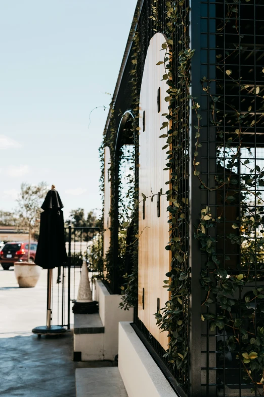 a building with a big window and some plant growing on it