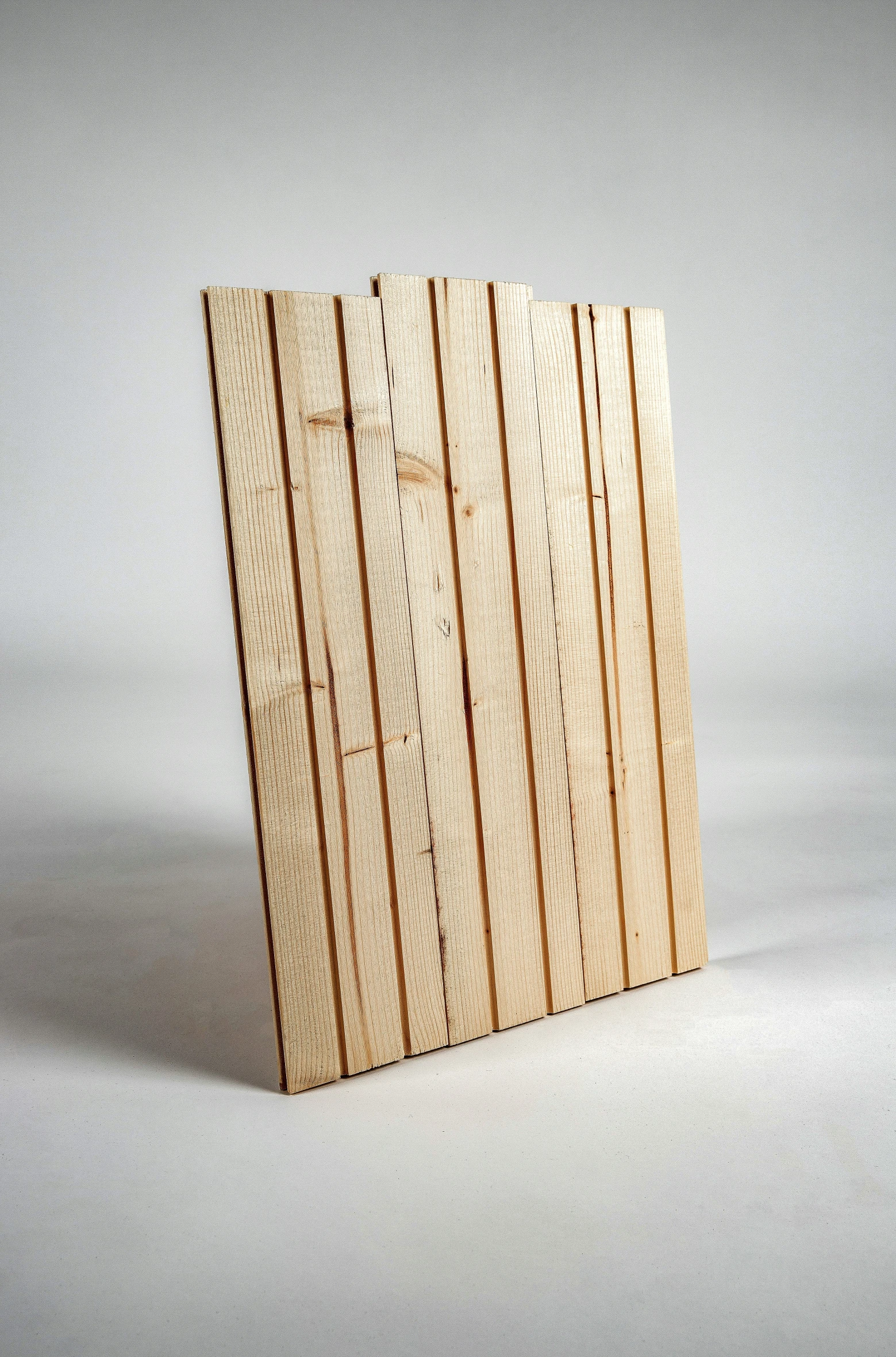 a wooden plaque with lines cut out of it