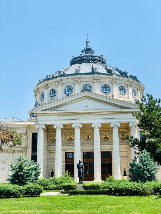 a large domed building with four pillars and a flagpole on top