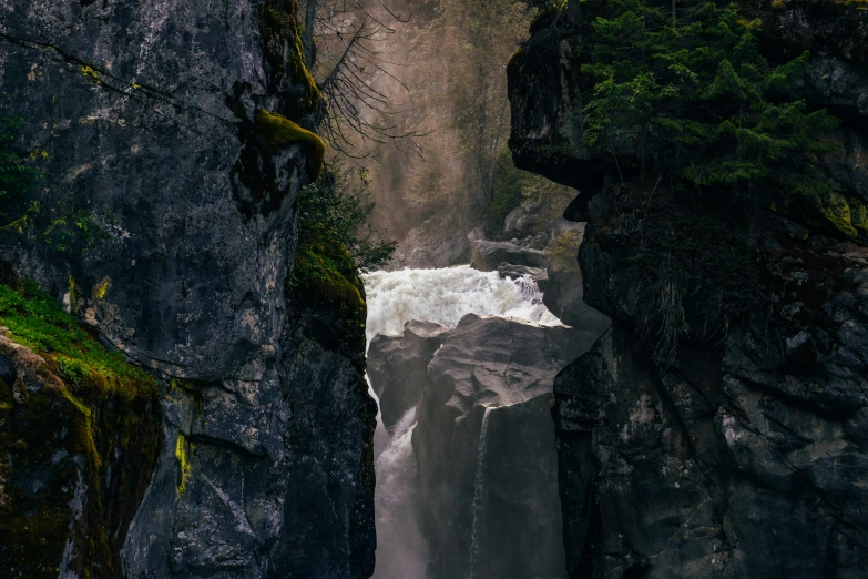 a waterfall on the side of a large cliff