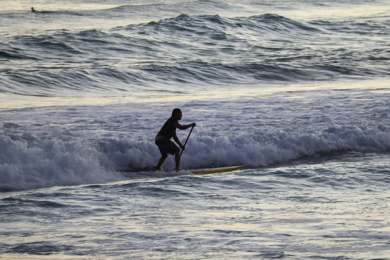 a man on a surfboard on the water with waves