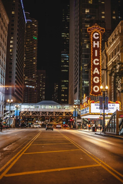 a city street with a lit up chicago sign on it