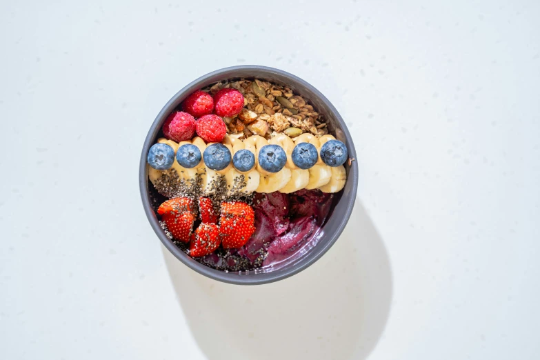 this fruit bowl is made up of granola and fresh fruits