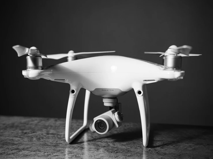 a black and white po of a small white remote control aerial camera