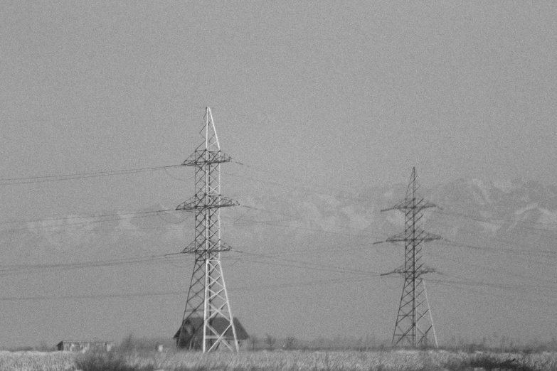 black and white po of utility towers in a field