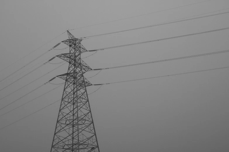 black and white pograph of power lines and wires in fog