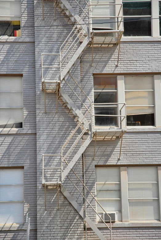 a couple of fire escapes mounted to the side of a building