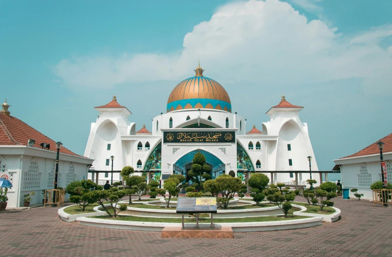 the front facade of a large white and yellow building with a gold dome