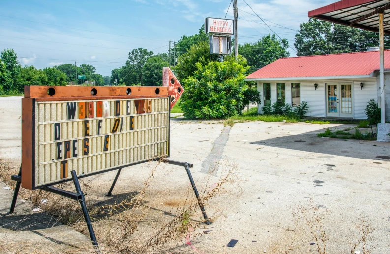 an old sign on the side of a road