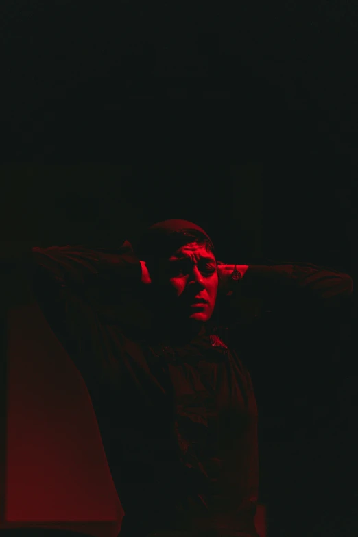 a man is looking away from the camera in red light