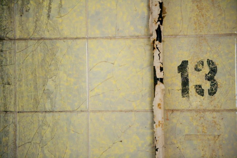 the bottom half of a bathtub with peeling paint on it