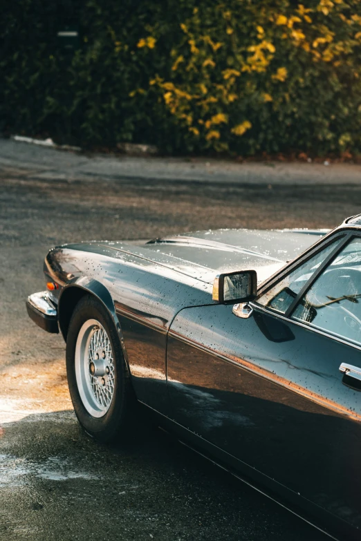 a classic sports car is parked on a street