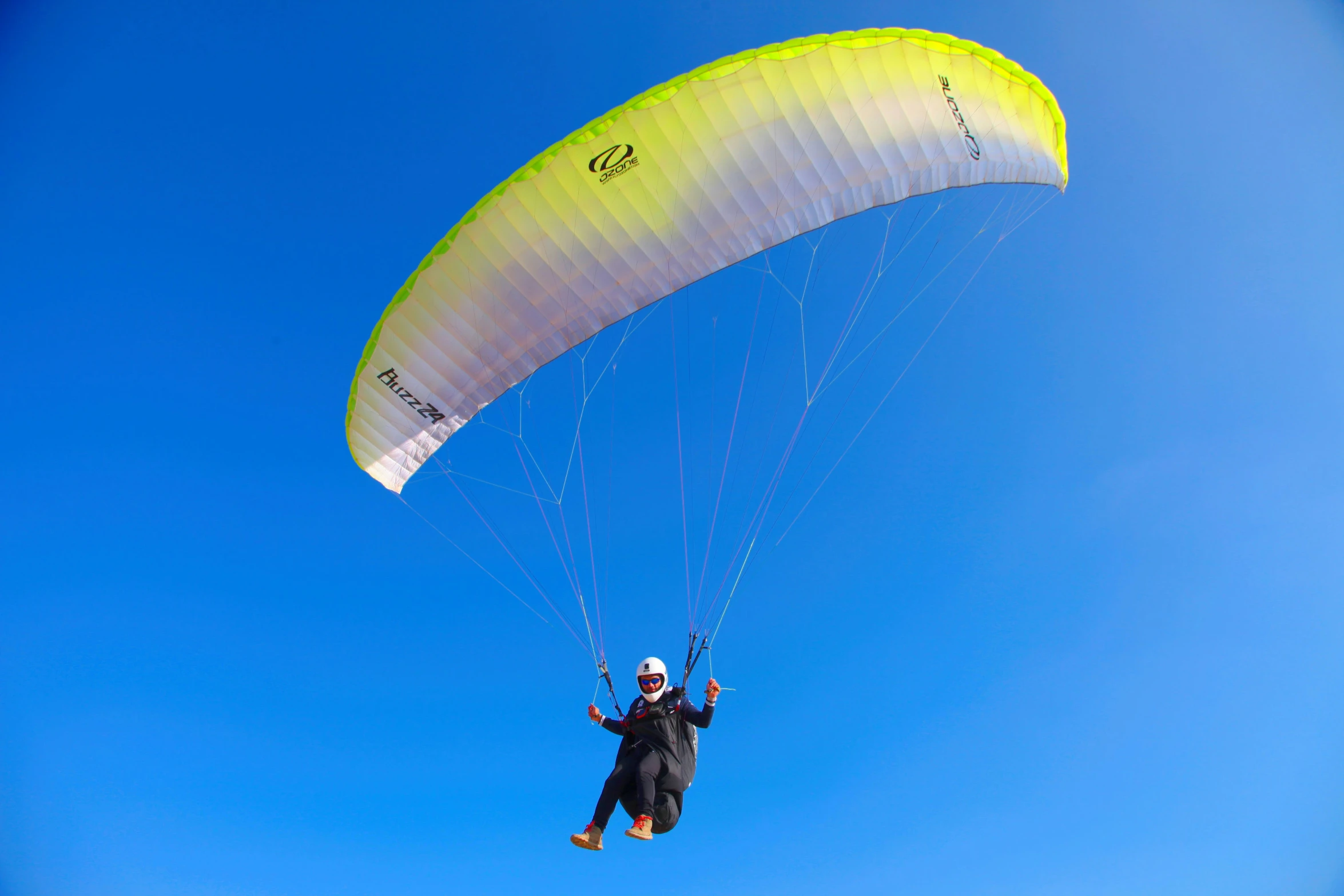 a parasailer in the air on a clear day